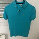 Polo Lacoste bleu turquoise, taille 10 ans en très bon état