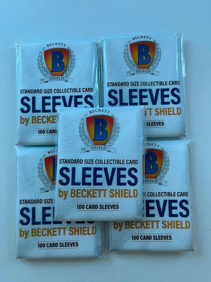 5 paquets de 100 sleeves Beckett Shields ( 500 sleeves ) - photo numéro 1