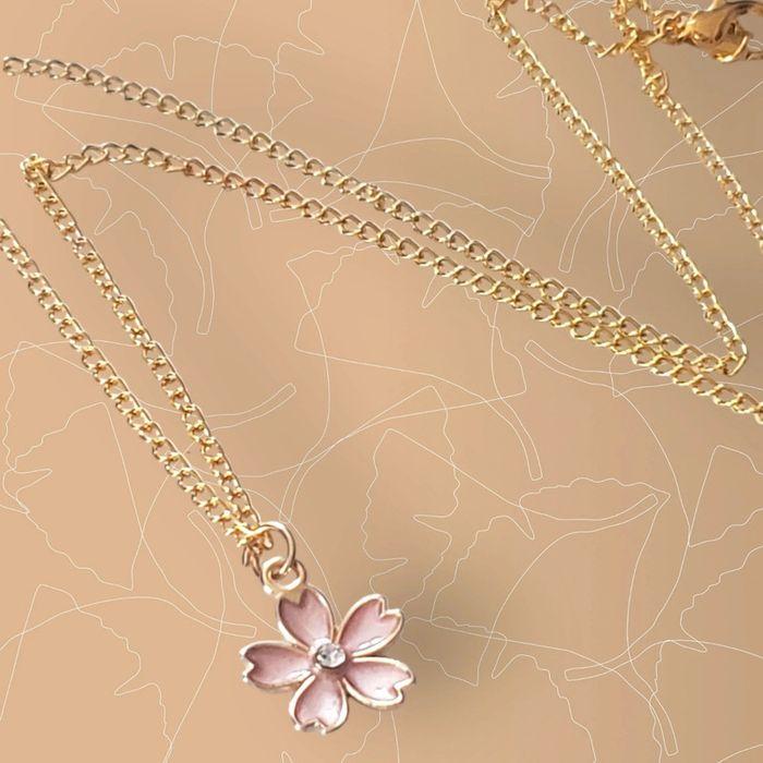 Collier dore avec sa chaîne et son pendentif fleur rose